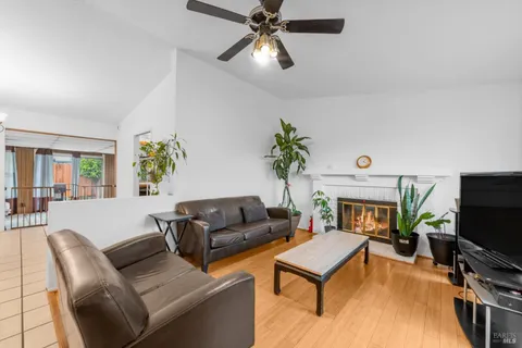 a living room with furniture a flat screen tv and a fireplace