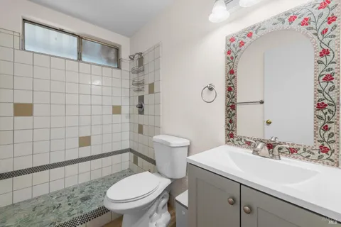 a bathroom with a sink a toilet and shower curtain