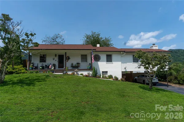 a view of a house with a yard porch and sitting area