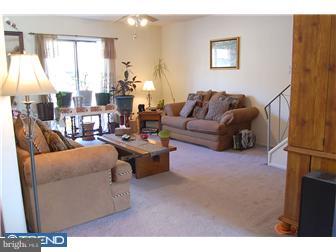 11849B Academy Road, Unit A49 Philadelphia, PA 19154 - Photo 2 of 6 a living room with furniture and a large window