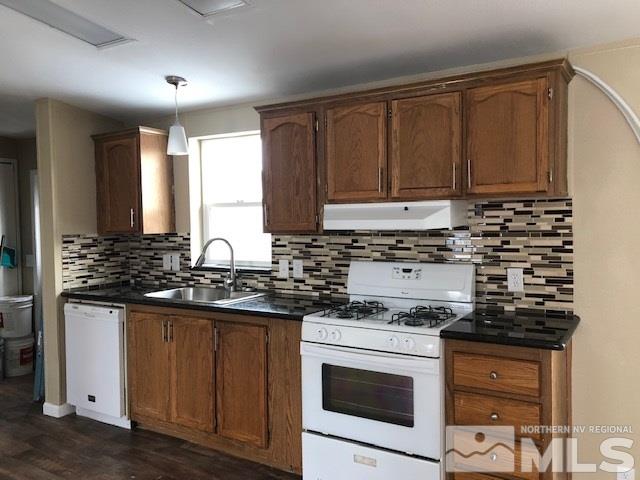 385 Vagabond Court Reno, NV 89506 - Photo 10 of 21 a kitchen with granite countertop a stove sink and cabinets