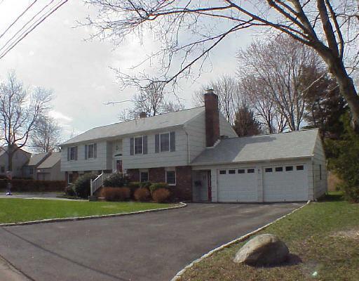 145 Birch Road Fairfield, CT 06824 - Photo 1 of 1 a front view of a house with a yard and a garage