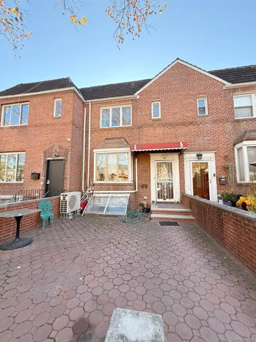 a front view of a house with many windows