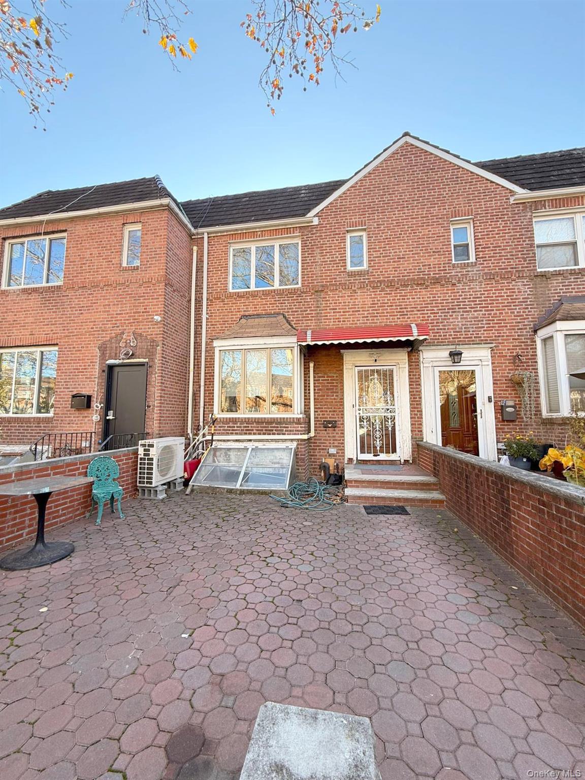 a front view of a house with many windows