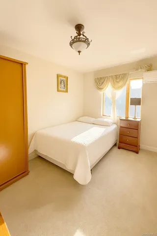 a spacious bedroom with a bed and a window