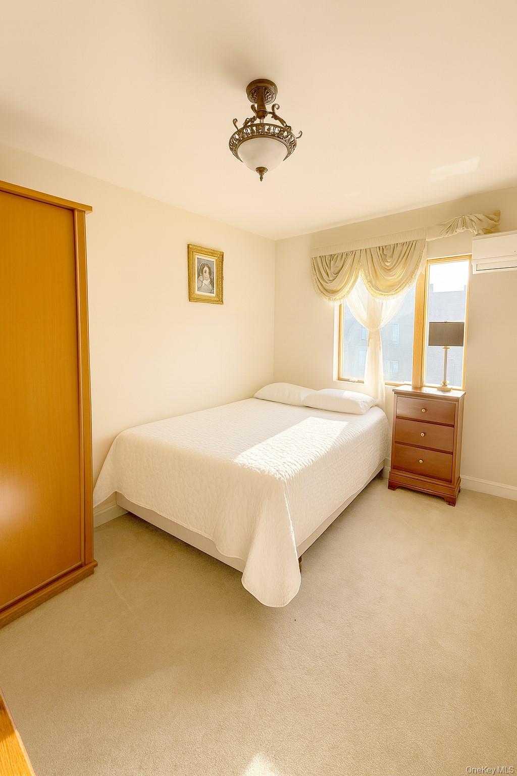 144-24 Jewel Avenue Queens, NY 11367 - Photo 12 of 12 a spacious bedroom with a bed and a window