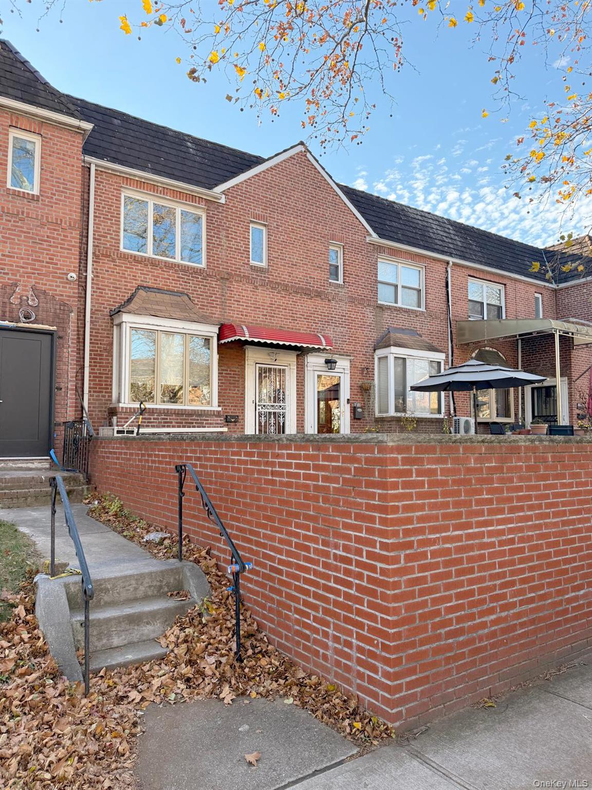 144-24 Jewel Avenue Queens, NY 11367 - Photo 2 of 12 a front view of a house with a garden