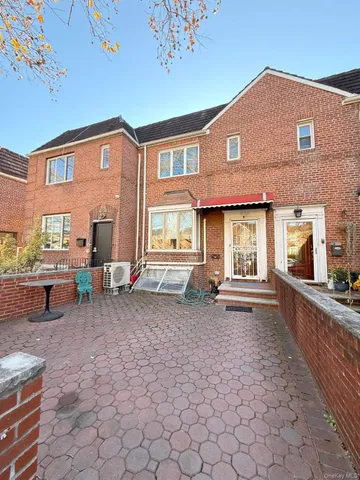 a view of a house with backyard porch and sitting area