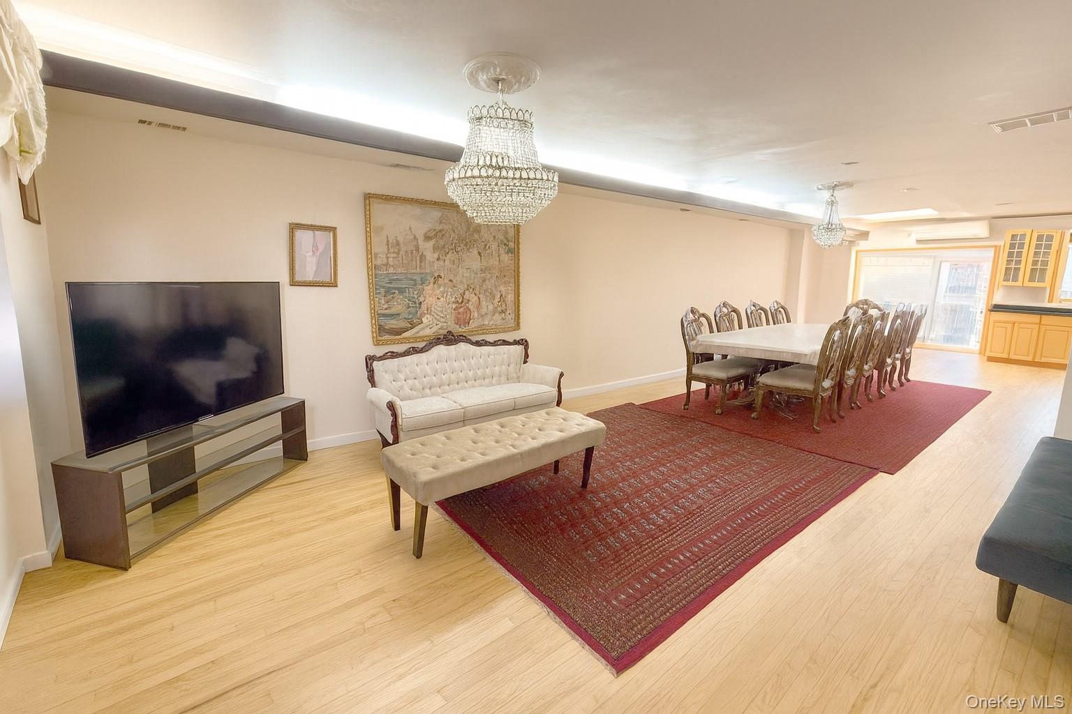 144-24 Jewel Avenue Queens, NY 11367 - Photo 4 of 12 a living room with furniture and a flat screen tv