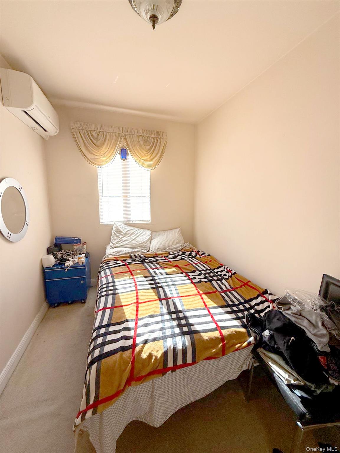 144-24 Jewel Avenue Queens, NY 11367 - Photo 9 of 12 a bedroom with a bed and a window