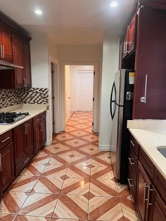 a kitchen with a sink stove and cabinets