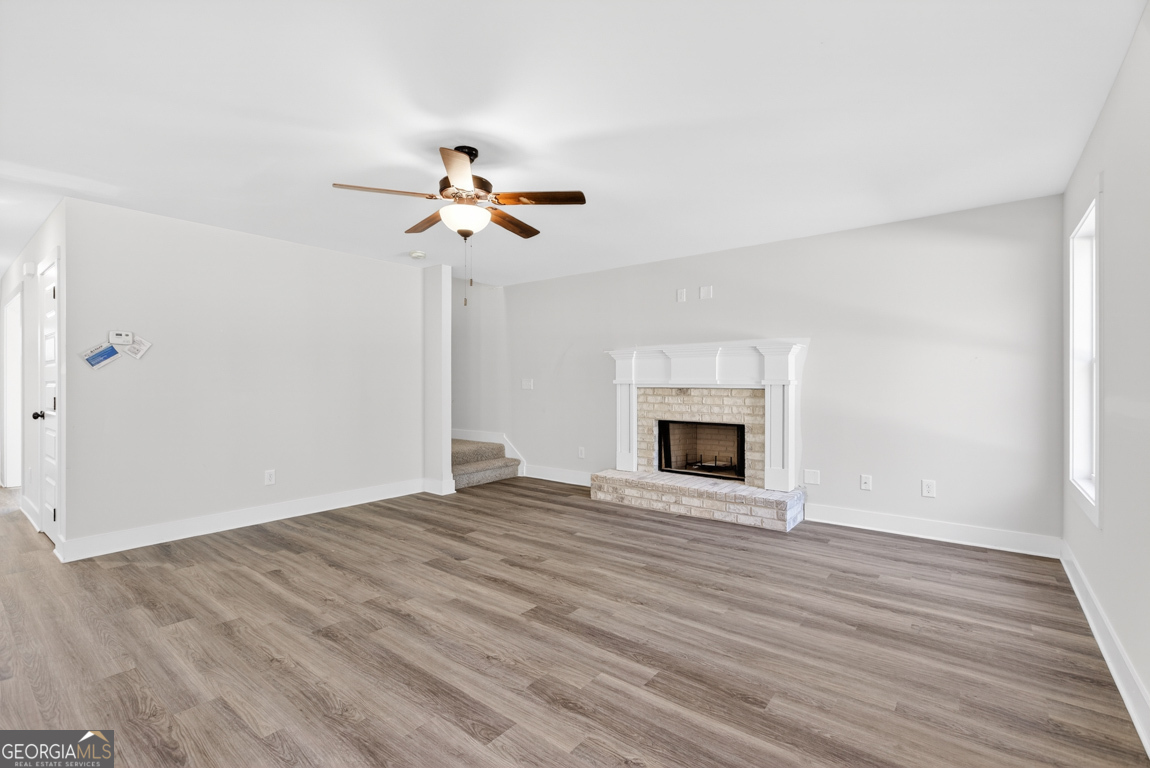 538 Oil Mill Road, Unit 8 Martin, GA 30557 - Photo 11 of 50 a view of empty room with wooden floor and fireplace