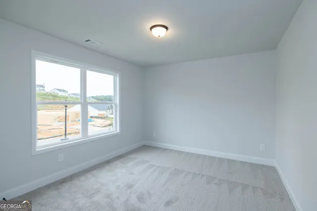 an empty room with a window and doors