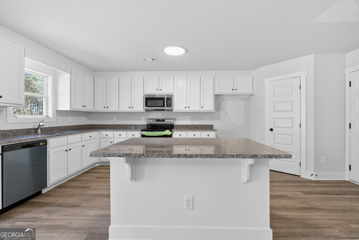 538 Oil Mill Road, Unit 8 Martin, GA 30557 - Photo 17 of 50 a kitchen with stainless steel appliances granite countertop a stove a sink and white cabinets
