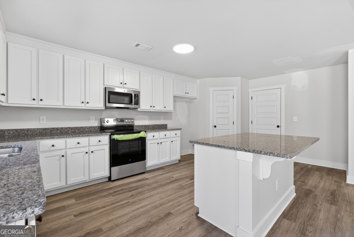538 Oil Mill Road, Unit 8 Martin, GA 30557 - Photo 18 of 50 a kitchen with stainless steel appliances granite countertop a stove a sink and white cabinets