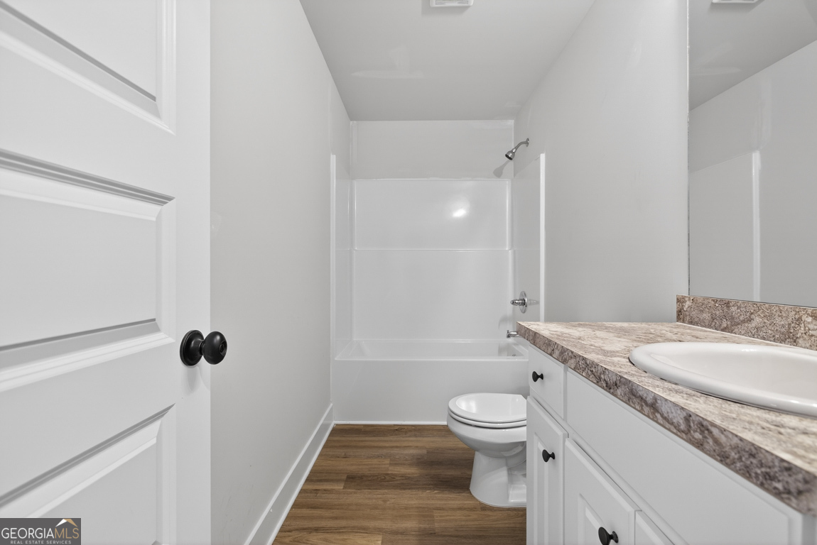 538 Oil Mill Road, Unit 8 Martin, GA 30557 - Photo 31 of 50 a bathroom with a granite countertop toilet a sink and a mirror