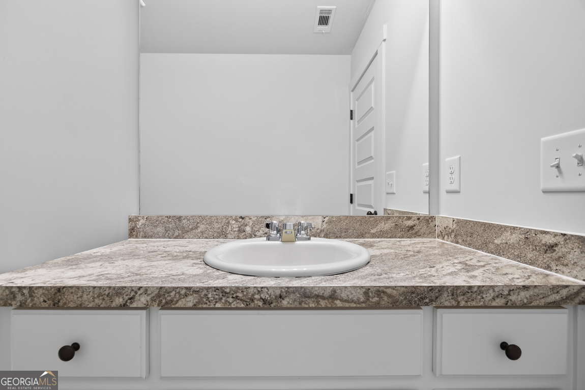 538 Oil Mill Road, Unit 8 Martin, GA 30557 - Photo 32 of 50 a bathroom with a granite countertop sink and a mirror