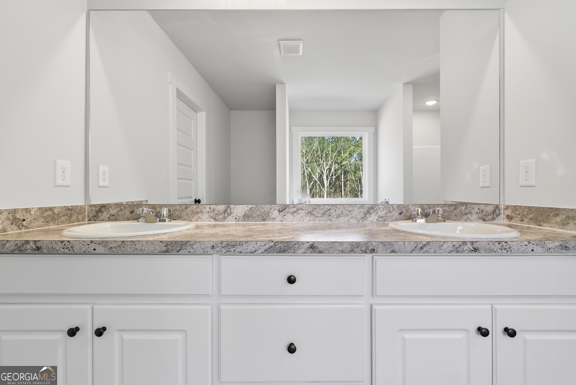 538 Oil Mill Road, Unit 8 Martin, GA 30557 - Photo 41 of 50 a bathroom with a granite countertop and white cabinets