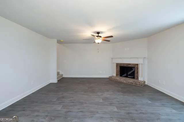 a view of an empty room with a fireplace