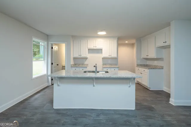 a kitchen with stainless steel appliances a sink stove and cabinets