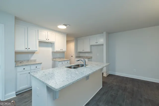 a kitchen with a sink stove and cabinets