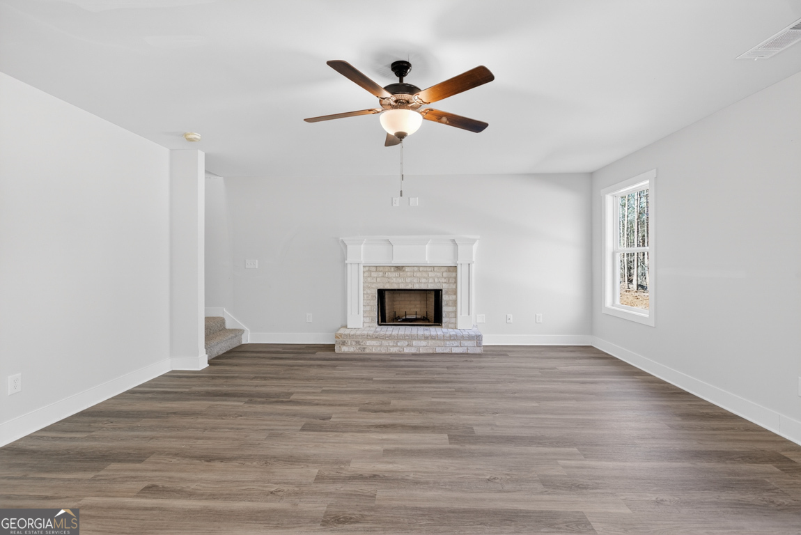 538 Oil Mill Road, Unit 8 Martin, GA 30557 - Photo 9 of 50 a view of an empty room with wooden floor and a fireplace