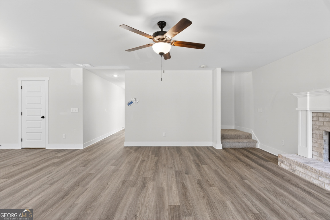 538 Oil Mill Road, Unit 8 Martin, GA 30557 - Photo 10 of 50 an empty room with wooden floor and ceiling fan