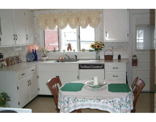 12 Maple Street Marblehead, MA 01945 - Photo 8 of 14 a kitchen with stainless steel appliances kitchen island granite countertop a stove a sink and a microwave