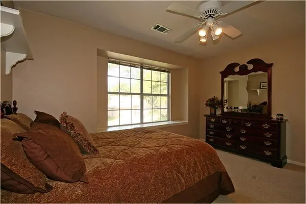 a bedroom with a bed and a dresser