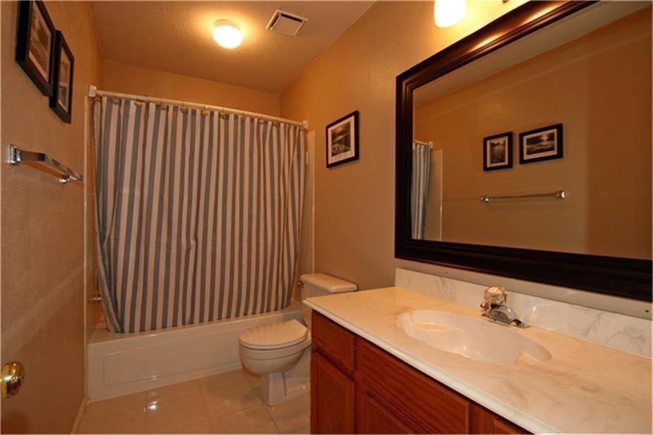 7 Thrush Grove Place Spring, TX 77381 - Photo 14 of 17 a bathroom with a sink and a toilet