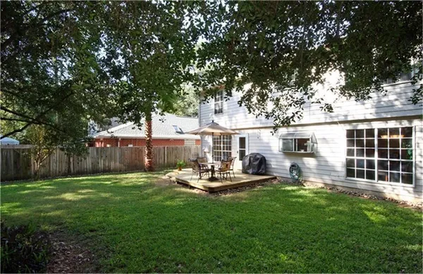 a view of a house with backyard and sitting area