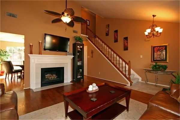 a living room with furniture a flat screen tv and a fireplace