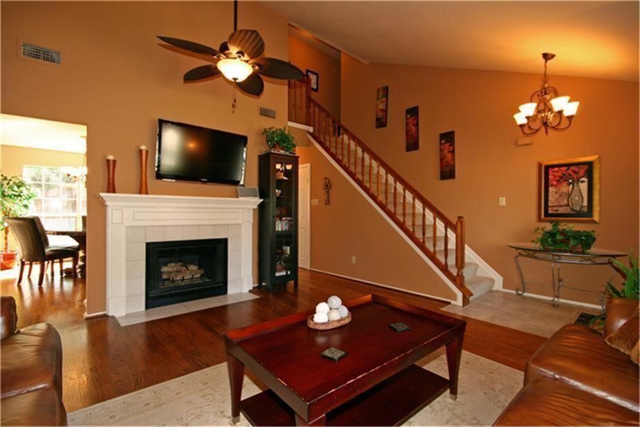 7 Thrush Grove Place Spring, TX 77381 - Photo 4 of 17 a living room with furniture a flat screen tv and a fireplace