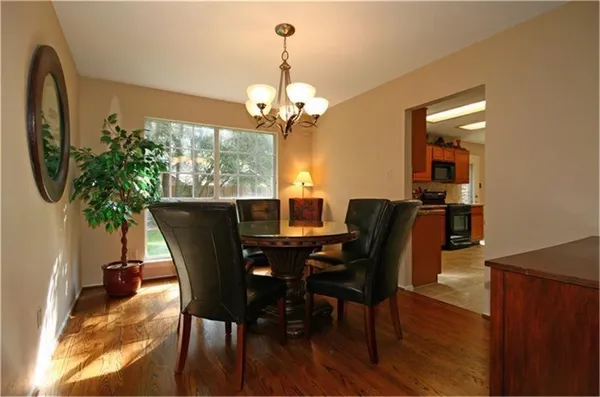 a view of a dining room with furniture wooden floor and chandelier