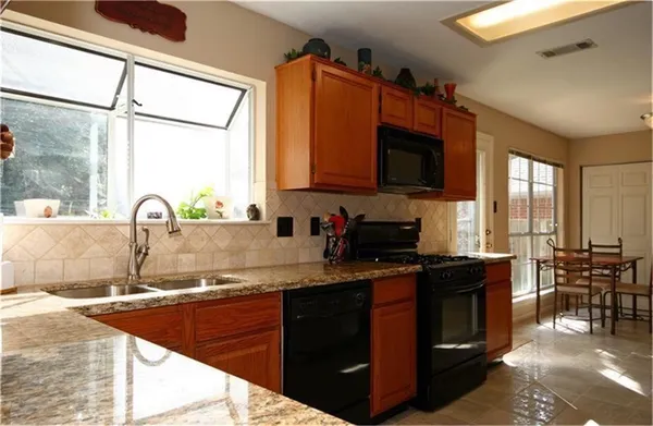 a kitchen with a sink stove and cabinets