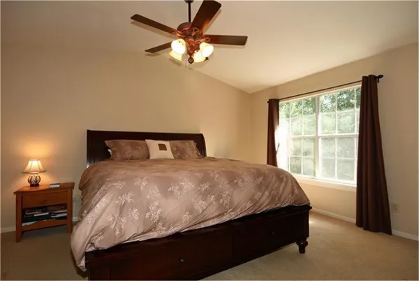 a bedroom with a bed and window