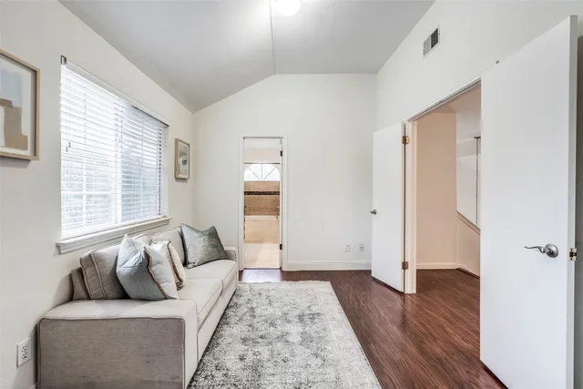 a bedroom with furniture and wooden floor