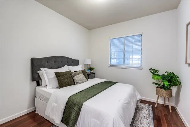 a bedroom with a bed running cycle and a window