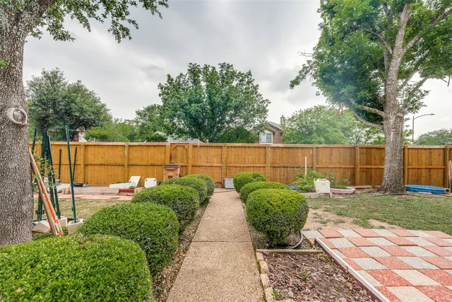 a view of backyard with outdoor seating and green space