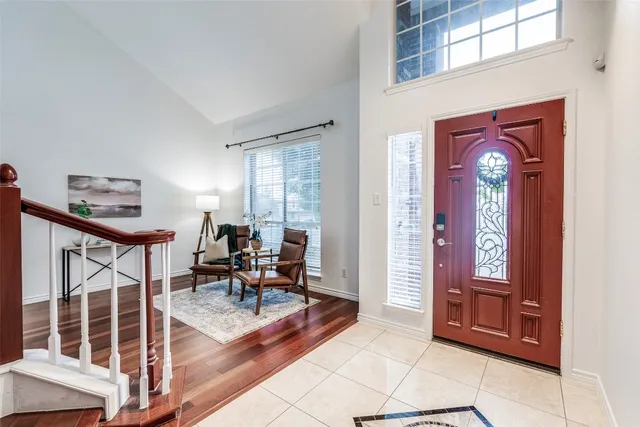 a living room with furniture a dining table and large windows