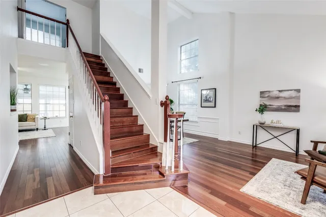 a view of entryway and hall with wooden floor