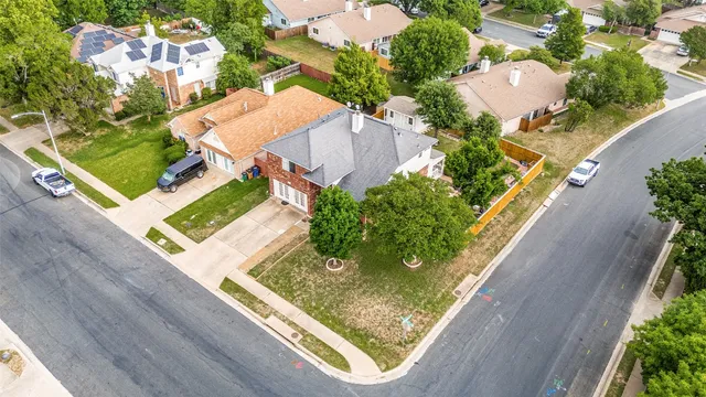 an aerial view of a house with a garden and lake view