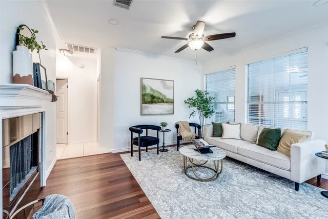 a living room with furniture a chandelier and a fireplace