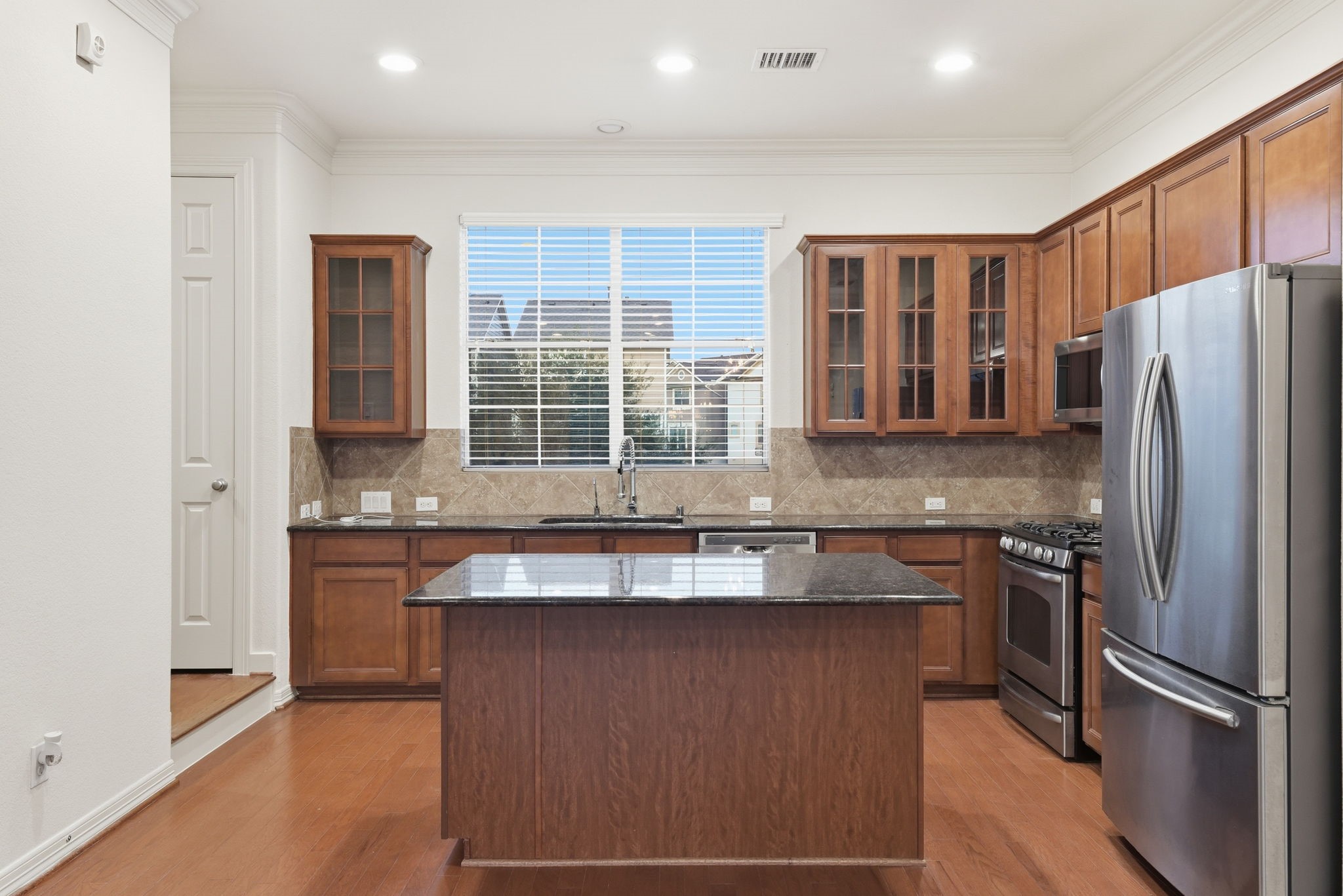 3209 Clearview Circle Houston, TX 77025 - Photo 18 of 40 a kitchen with stainless steel appliances granite countertop a refrigerator and a sink