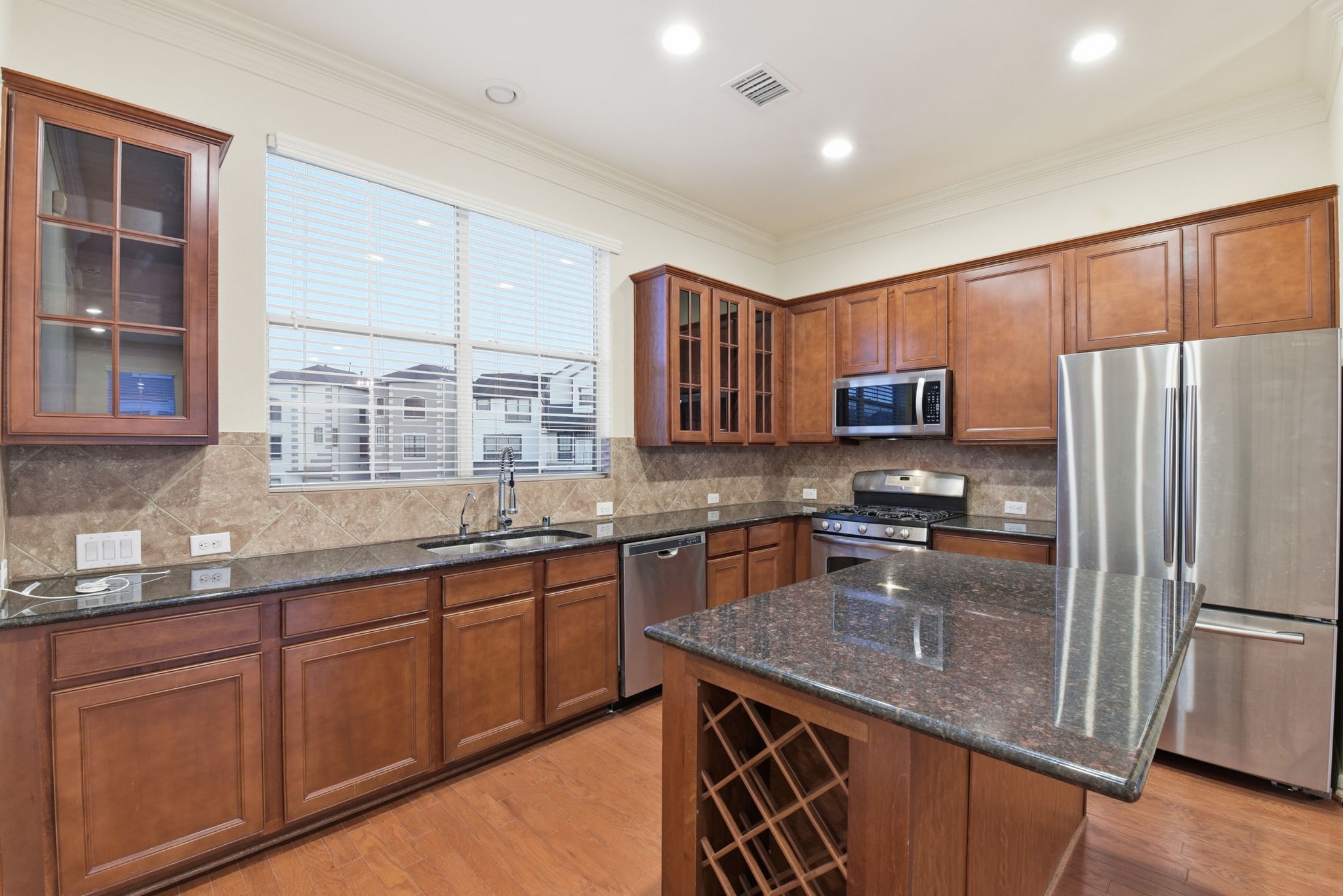 3209 Clearview Circle Houston, TX 77025 - Photo 19 of 40 a kitchen with stainless steel appliances granite countertop a sink stove refrigerator and cabinets