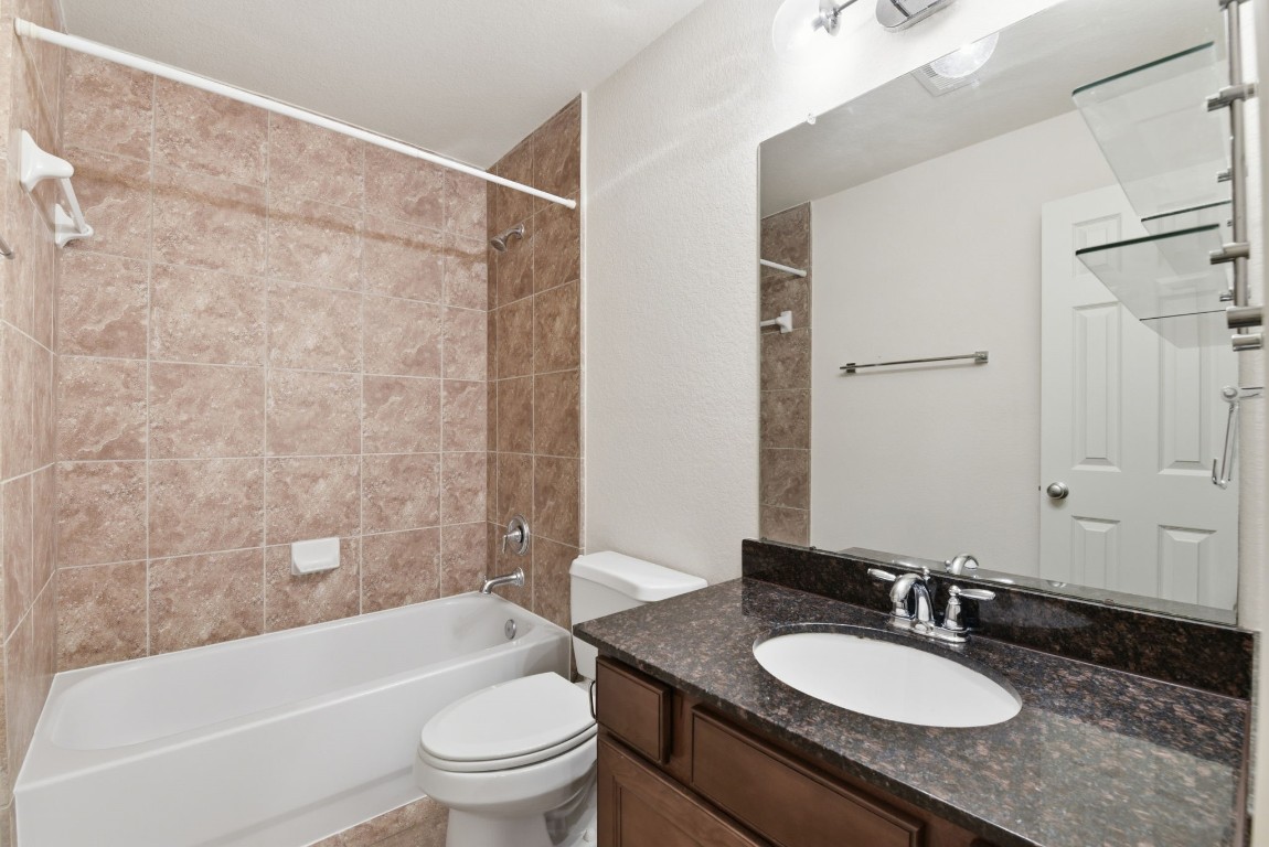 3209 Clearview Circle Houston, TX 77025 - Photo 37 of 40 a bathroom with a granite countertop sink toilet tub and shower