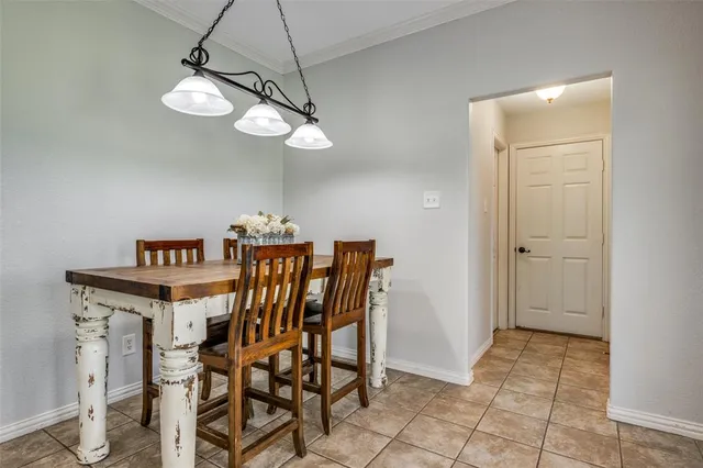 a view of a dining room with furniture and chandelier