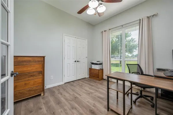 a bed sitting in a spacious bedroom next to a window
