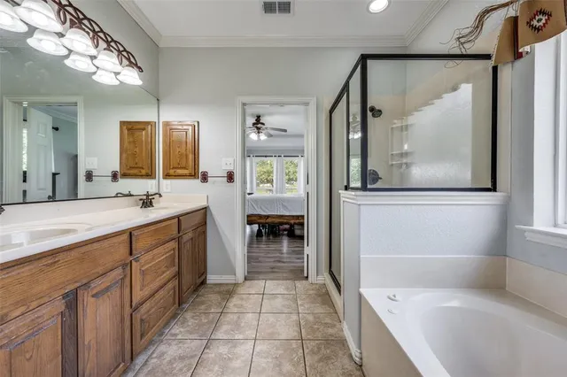 a spacious bathroom with a tub sink and mirror