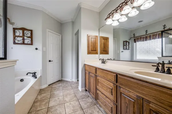 a spacious bathroom with a tub sink and mirror